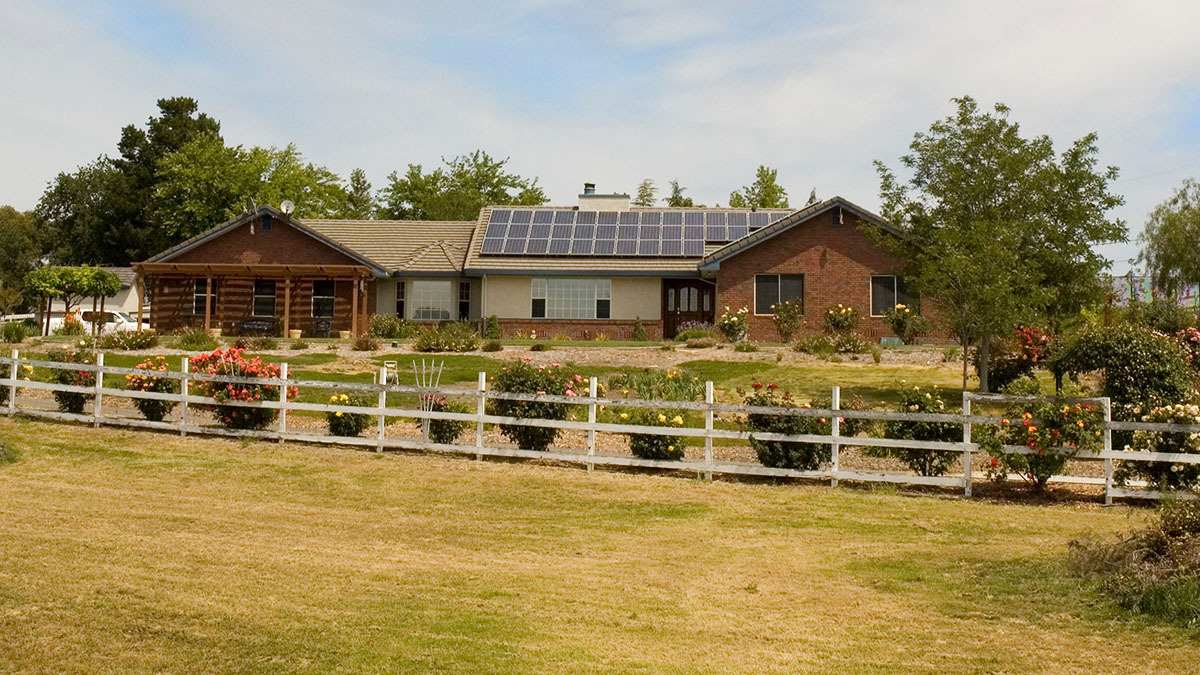 Urban home with solar panels on the roof for energy saving.